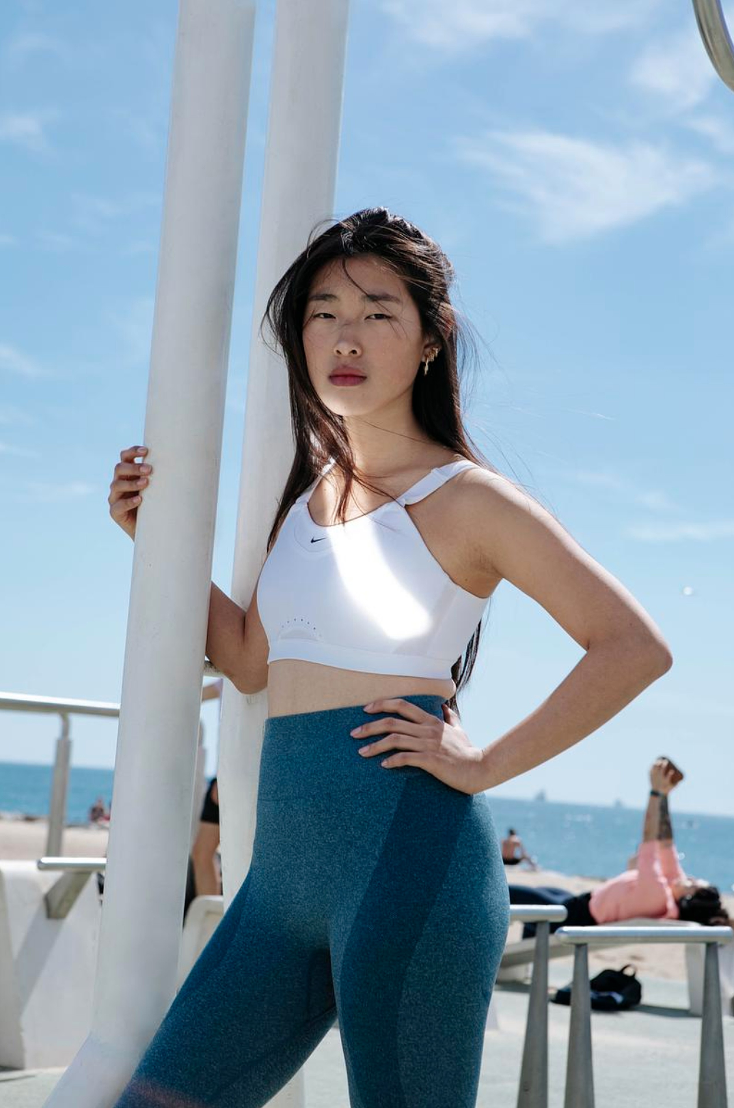 Elio member standing on a sunny beachfront